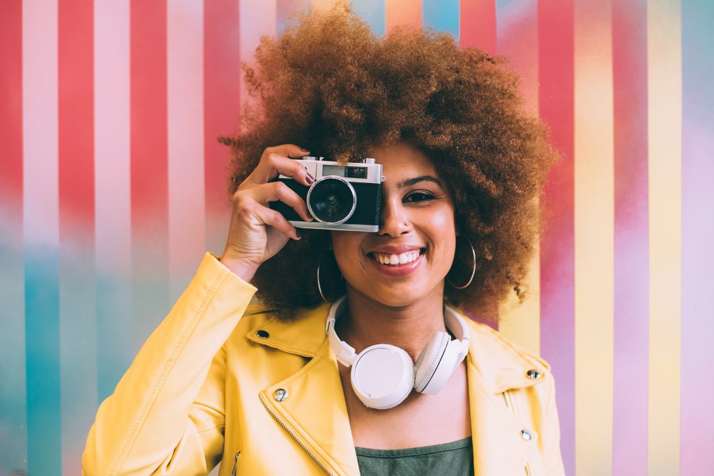 Vrouw met camera werkt aan visuele merkidentiteit